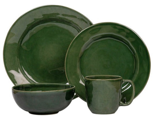 A green ceramic dinnerware set featuring two plates, a bowl, and a mug from the Juliska Puro Basil Collection for a complete table setting.