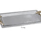 The Beatriz Ball Ocean Coral Emerson Tray Collection features a rectangular aluminum alloy tray with a textured surface, ornate gold handles, and "Long" labeled underneath.
