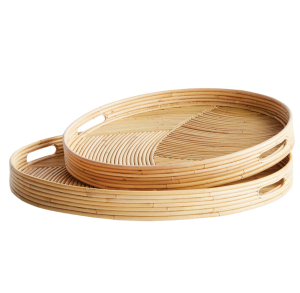 The Napa Home Jelani Cane Round Tray Collection by Napa Home & Garden features two stacked oval woven bamboo trays with handles, showcasing a geometric rattan-like pattern perfect for serving.