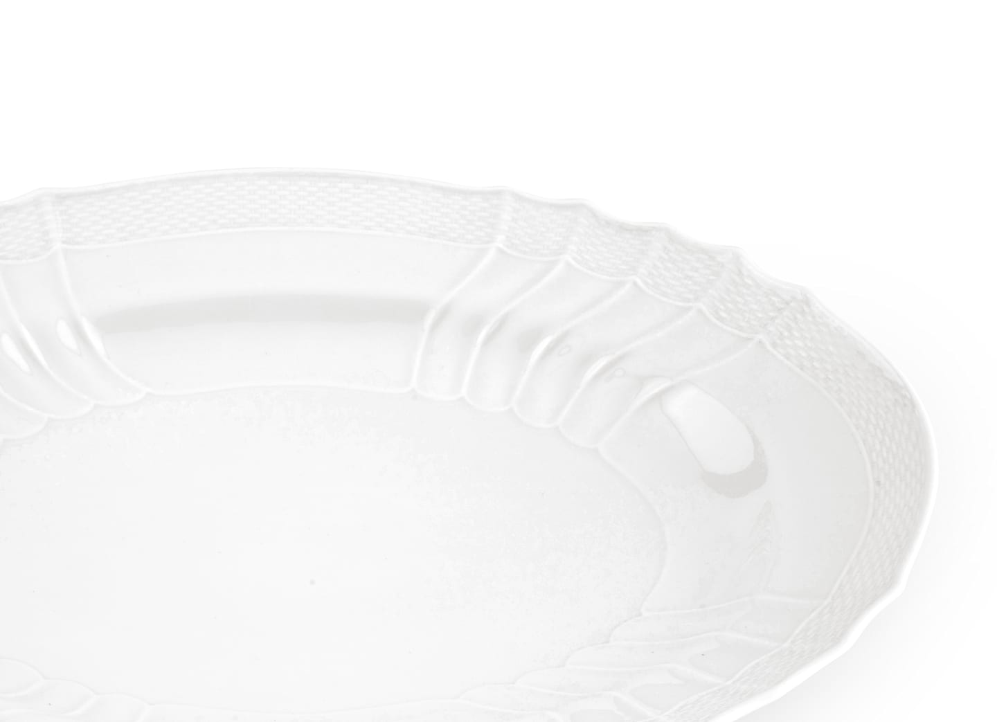 A close-up of the Vecchio White Oval Platter by Ginori 1735, featuring a textured, scalloped rim and showcasing exquisite craftsmanship on a plain white background.
