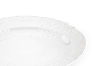 A close-up of the Vecchio White Oval Platter by Ginori 1735, featuring a textured, scalloped rim and showcasing exquisite craftsmanship on a plain white background.