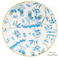The Oro Di Doccia Turchese Dinnerware Collection by Ginori 1735 features a round porcelain plate with hand-painted gold accents, blue floral designs, Ji Ondori roosters, scalloped edges, and gold trim; “Dessert/Salad Plate” in bottom right.
