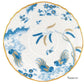 Porcelain saucer from the Oro Di Doccia Turchese Dinnerware Collection by Ginori 1735, featuring a hand-painted gold rim and blue floral and bird motif on white. "Saucer" is printed in the lower right corner.