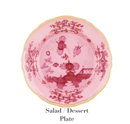 The Ginori 1735 Oriente Italiano Porpora Dinnerware Collection features a pink and red floral salad/dessert plate with scalloped yellow-trimmed edges, showcasing Italian elegance on a white background. Text below: "Salad / Dessert Plate.
