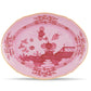 The Oriente Italiano Porpora Dinnerware & Decor Collection by Ginori 1735 features a pink porcelain plate with red floral motifs and geometric borders, adding elegance and style to any home decor accessories collection.