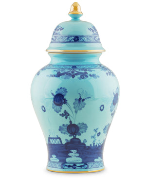 The Ginori 1735 Oriente Italiano Iris with Gold Vase and Cover is a blue and white porcelain piece featuring floral patterns, gold accents, and a lid, inspired by classic Potiche vases.