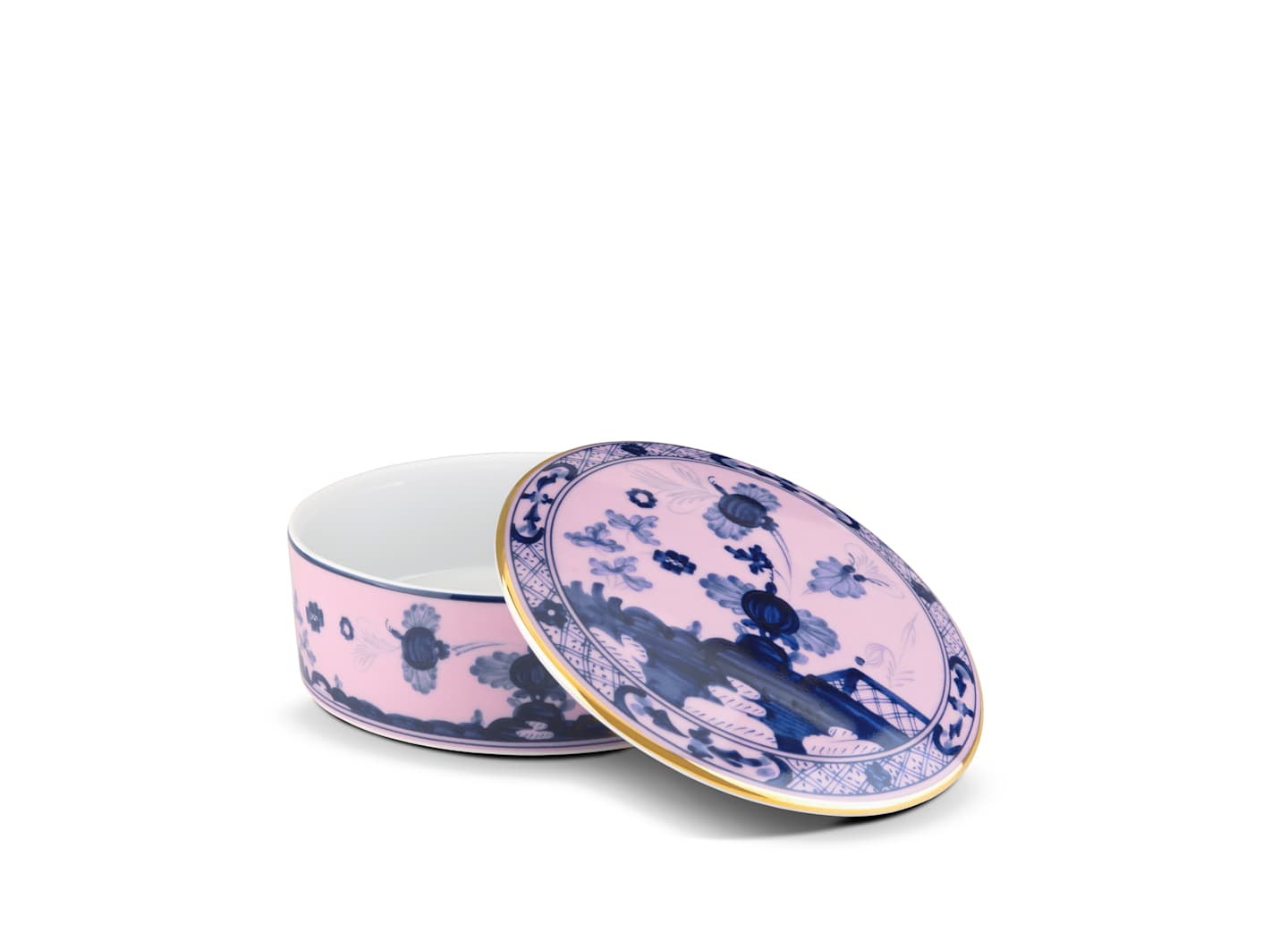 The Oriente Italiano Azalea Serveware & Decor Collection by Ginori 1735 features a round porcelain box with blue floral and landscape patterns on a pink background, gold rim accents, and a removable lid—ideal for elegant home decor.