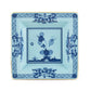 Oriente Italiano Iris with Gold square ceramic plate by Ginori 1735, in blue and white with floral and bee motifs inspired by Faenza ceramics, artistic border detailing, and a glossy finish, displayed from above on a white background.