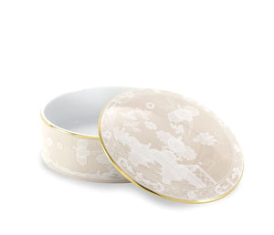 A round porcelain box from Ginori 1735’s Oriente Italiano Meringa Dinnerware & Serveware Collection features a floral motif and gold trim, shown with its matching lid slightly ajar—a striking piece for elegant table settings.