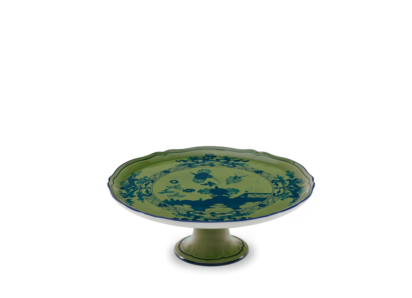 The Oriente Italiano Malachite cake stand by Ginori 1735 features a green ceramic body with a blue exotic floral pattern, scalloped edge, and pedestal base, shown against a plain white background.