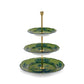 The Oriente Italiano Malachite three-tiered stand by Ginori 1735 features green floral porcelain plates, elegantly stacked from largest to smallest with a gold central rod.