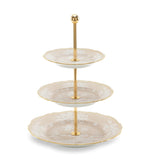 The Ginori 1735 Oriente Italiano Meringa Collection features a three-tiered serving stand with gold support and three round, scalloped-edge porcelain plates in an elegant pattern.