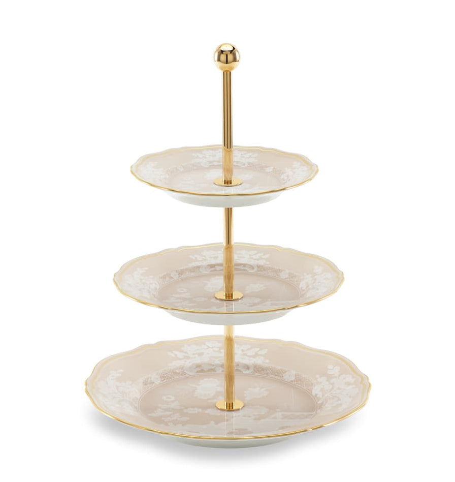 The Ginori 1735 Oriente Italiano Meringa Collection features a three-tiered serving stand with gold support and three round, scalloped-edge porcelain plates in an elegant pattern.