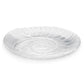 The Shell Serveware Collection by Simon Pearce features a clear glass, shell-shaped bowl with an embossed spiral pattern—perfect for beach-inspired decor or as a unique summer host gift.