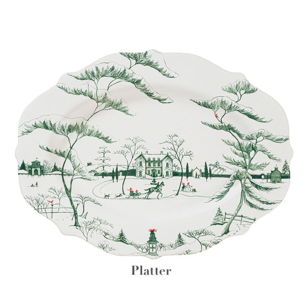 The Juliska Country Estate Winter Frolic Evergreen Dinnerware Collection features a white stoneware platter with a green winter landscape, trees, house, skaters, and red accents—ideal for festive gatherings or adding country estate charm.