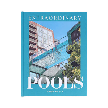 The book "Extraordinary Pools" from Chronicle Books features a cover image of a glass-bottom pool suspended between buildings, showcasing architecturally significant swimming pools.