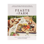The cover of "Feasts on the Farm" by Chronicle Books shows a picnic table outdoors with bread, cheese, eggs, and fruit.