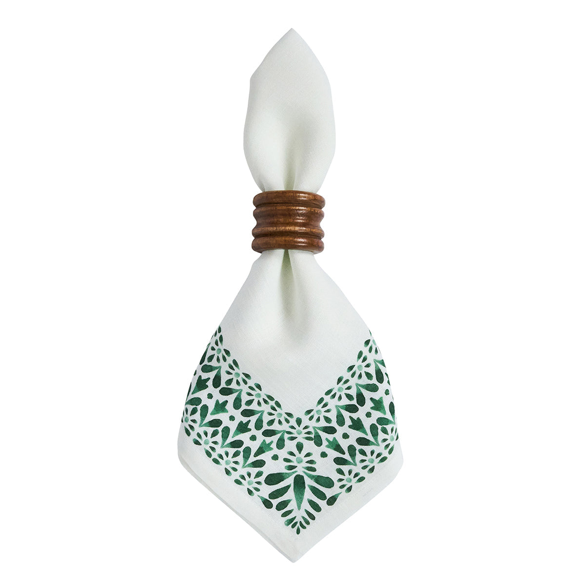 The Iberian Evergreen Border Napkin Set by Juliska features white linen napkins with a green decorative border, elegantly held by a round wooden napkin ring and showcased against a white background—perfect for refined table settings inspired by classic Iberian motifs.