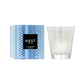 A Blue Cypress & Snow Collection candle from Nest is displayed beside its blue-patterned box, showcasing the winter scent by Nest.