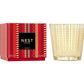 A red patterned NEST Holiday Collection fragrance box sits next to a glass candle vessel with a gold geometric design.