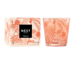 Nest’s Something Tropical Candle and Diffuser Collection features a decorative peach-toned box and glass with palm and floral designs, filling your space with passion fruit notes for an irresistibly lush ambiance.