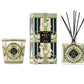 A glass 3-wick candle, a rectangular reed diffuser box, and a Birchwood Pine glass diffuser bottle from the Nest Pierre Marie Birchwood Collection, decorated with a green, cream, and black carousel.