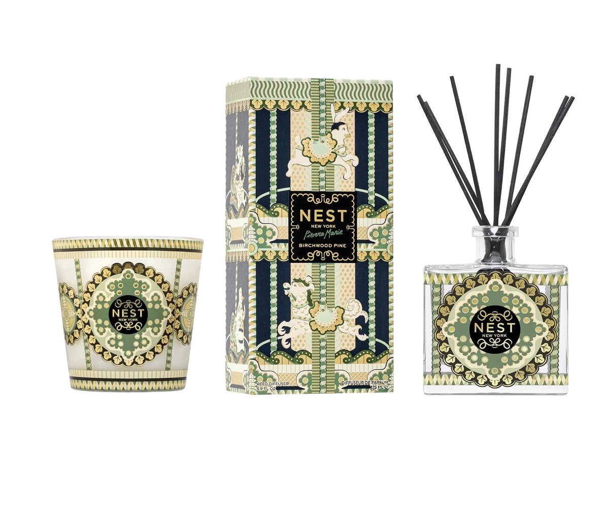 A glass 3-wick candle, a rectangular reed diffuser box, and a Birchwood Pine glass diffuser bottle from the Nest Pierre Marie Birchwood Collection, decorated with a green, cream, and black carousel.