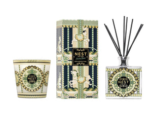 A glass 3-wick candle, a rectangular reed diffuser box, and a Birchwood Pine glass diffuser bottle from the Nest Pierre Marie Birchwood Collection, decorated with a green, cream, and black carousel.