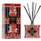 Nest Pierre Marie Holiday Collection reed diffuser set featuring a square glass bottle, black reeds, and a box with carousel horses and ornate red, gold, and blue designs.