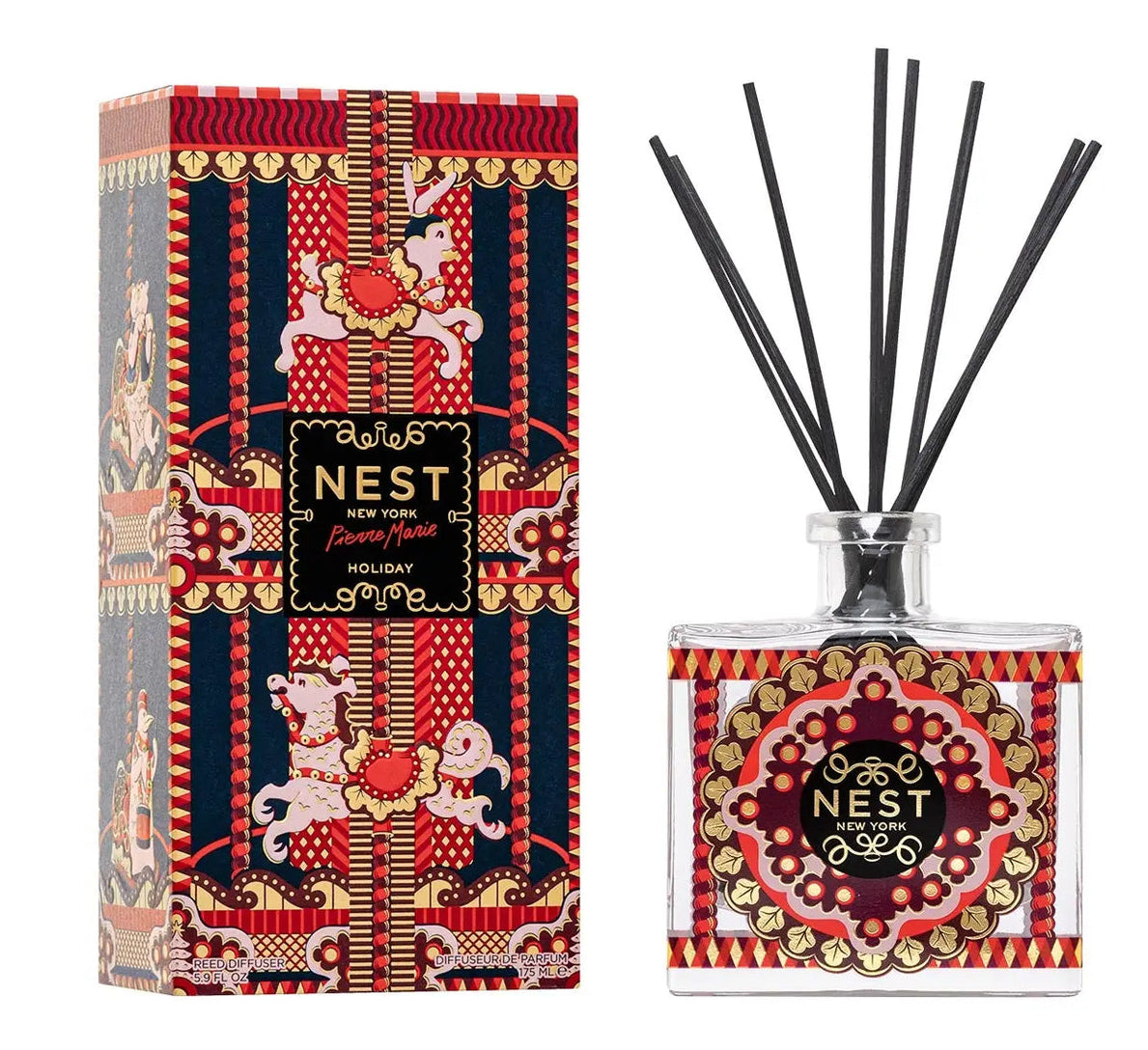 Nest Pierre Marie Holiday Collection reed diffuser set featuring a square glass bottle, black reeds, and a box with carousel horses and ornate red, gold, and blue designs.