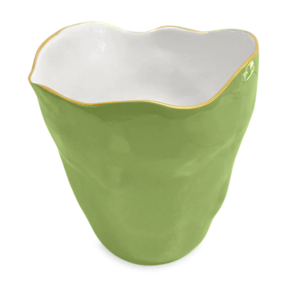 The ENCANTO Collection by Beatriz Ball features a green enamel ceramic cup with an uneven rim, white interior, and thin gold-toned edge accent.
