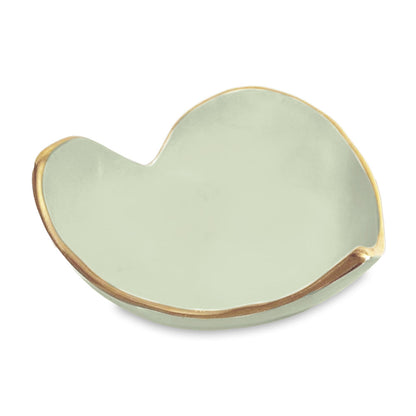 The Beatriz Ball Encanto Soho Mini Heart Dish Collection features a small, pale green ceramic dish with a gold-rimmed abstract shape—perfect as a unique handmade gift.