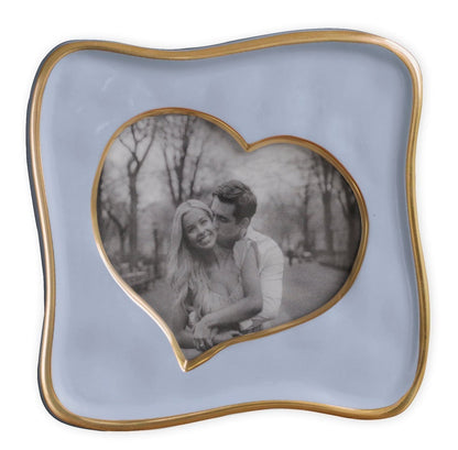 A black-and-white photo of a smiling couple in the Encanto Curved Heart Frame Collection, 5x5 by Beatriz Ball—an abstract heart frame set within a wavy square with gold trim.