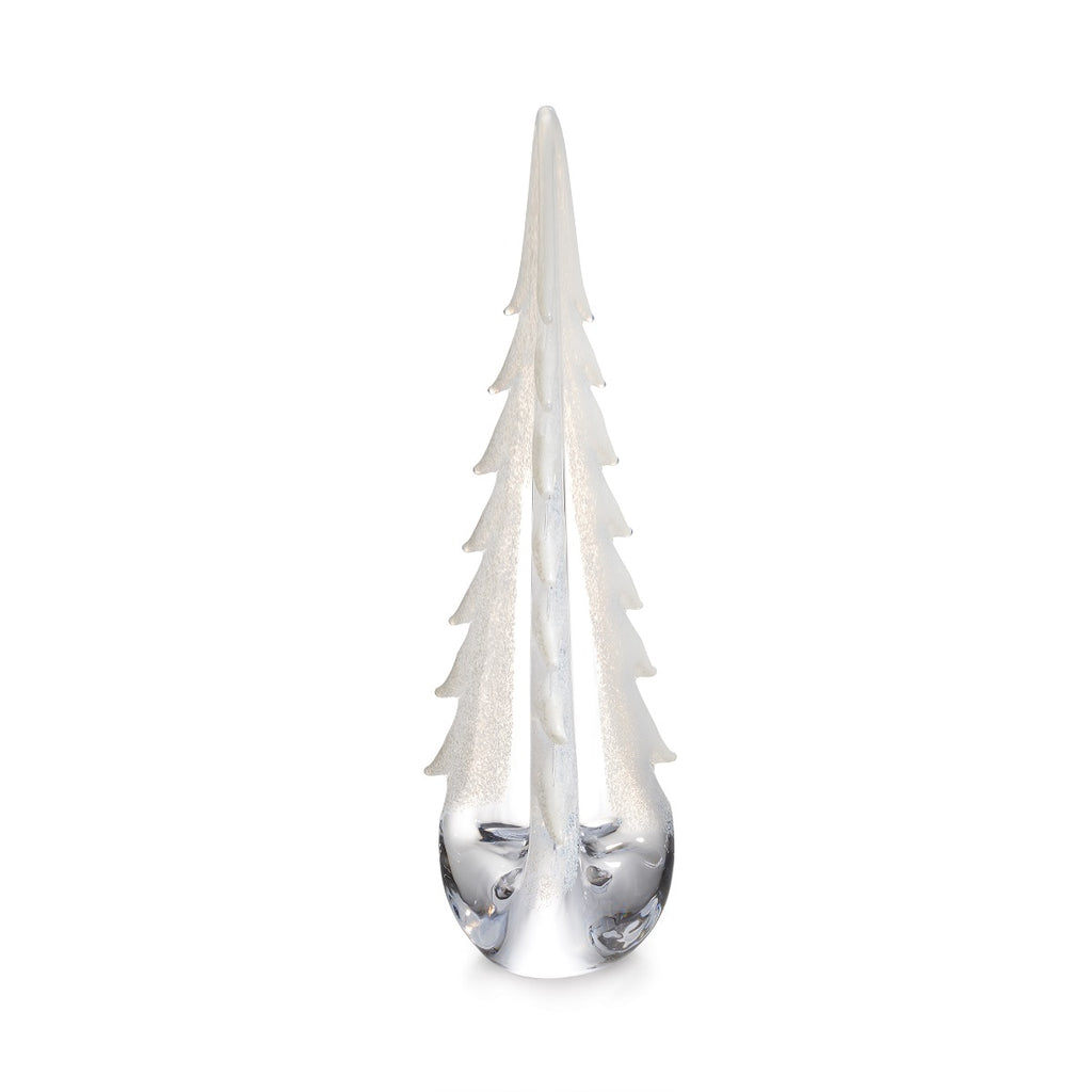 The Simon Pearce Snowy Branches Evergreen Tree Collection features clear glass sculptures inspired by Vermont's winter woods, with textured, frosted branches and smooth bases—a signature design.