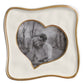 A handcrafted 5x5 Encanto Curved Heart Frame by Beatriz Ball displays a black-and-white photo of a smiling couple and features a wavy gold border, abstract heart shape, and charming trees and path in the background.