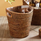 The Napa Home & Garden Burma Rattan Beverage Tub, featuring two side handles and a watertight design, rests on a wooden surface. Another similar basket and objects are partially visible in the background.
