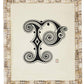 From Pigeon & Poodle’s Mombasa Frame Collection, this framed artwork displays an ornate black and white letter "P" with decorative swirls and geometric patterns on a subway tile-inspired textured background.