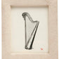 The Ancona Frame Collection by Pigeon & Poodle displays a harp illustration on white, accented by a small red dog icon in the corner—a subtle homage to Ancona.