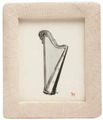The Ancona Frame Collection by Pigeon & Poodle displays a harp illustration on white, accented by a small red dog icon in the corner—a subtle homage to Ancona.
