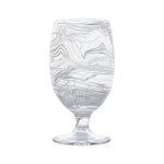 The Puro Marbled Drinkware Collection by Juliska features a clear glass goblet with swirling sea-glass hues, elegantly displayed against a plain white background.