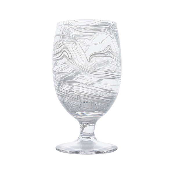 The Puro Marbled Drinkware Collection by Juliska features a clear glass goblet with swirling sea-glass hues, elegantly displayed against a plain white background.