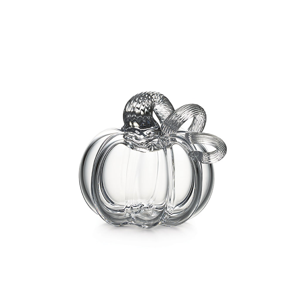 The Simon Pearce Glass Pumpkin with a Twist features a curved stem and leaf detail, handcrafted in clear glass—perfect for autumn decor and beautifully displayed on a white background.