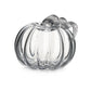 The Simon Pearce Glass Pumpkin with a Twist is a clear glass, pumpkin-shaped ornament featuring a ribbed stem—ideal for autumn decor and pictured on a white background.