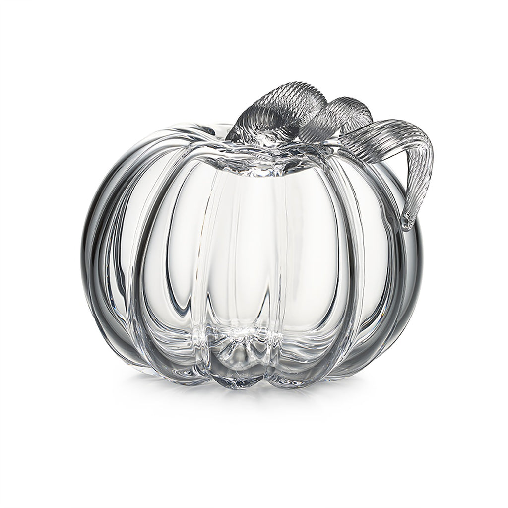 The Simon Pearce Glass Pumpkin with a Twist is a clear glass, pumpkin-shaped ornament featuring a ribbed stem—ideal for autumn decor and pictured on a white background.
