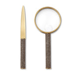 The Aerin Shagreen Magnifying Glass & Letter Opener Set features matching pieces with textured brown handles, elegantly displayed on a white background—a stylish gift for any desk.