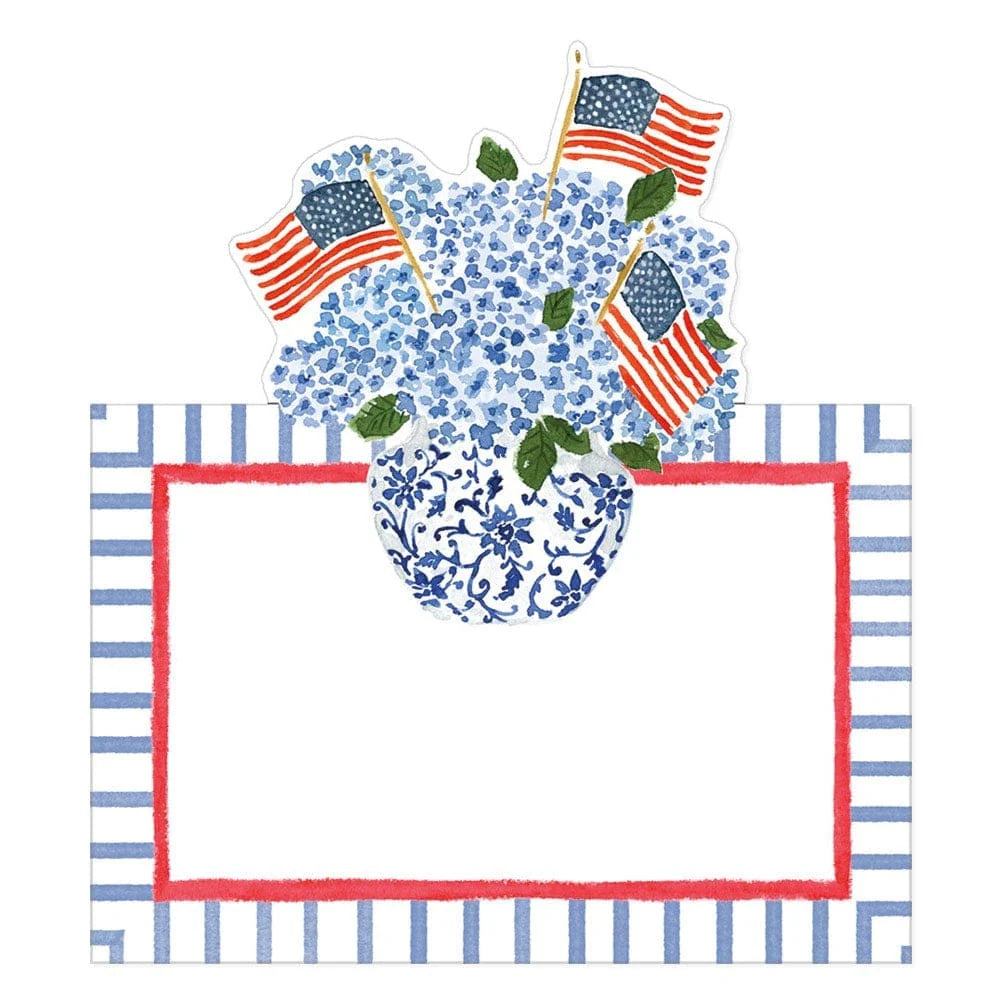 The Flags And Hydrangeas Collection by Caspari features a blue and white floral vase with hydrangeas and American flags, set above a blank red-bordered label—ideal for patriotic outdoor gatherings.