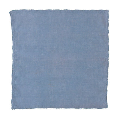 The Berry Trim Napkin Collection by Juliska features a square blue woven cotton napkin with subtle texture and a simple stitched border, shown on a white background.