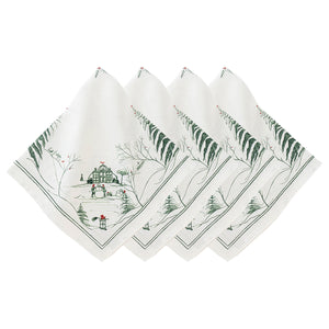 The Juliska Country Estate Winter Frolic Evergreen Napkins, Set of 4, feature white cotton napkins decorated with green trees, houses, snowmen, and snow—perfect festive linens for your seasonal gatherings.