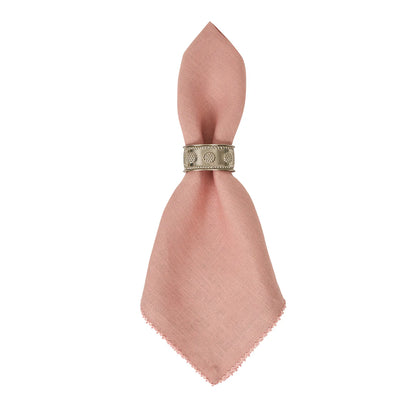The Berry Scallop Napkin Set by Juliska features pink woven linen napkins held by a decorative silver napkin ring with embossed detailing.