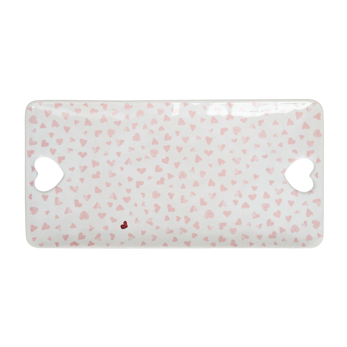 From Juliska's Love You More Decor and Tabletop Collection: a rectangular white tray with pink heart pattern, heart-shaped side cutout handles, and a small red heart—ideal for serving or displaying love-themed tableware.
